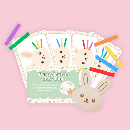 Children's educational game with bunny cards and a toy on a pink background